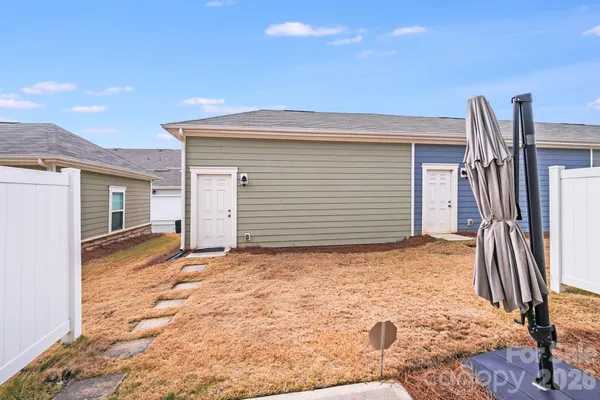 a view of a house with backyard and parking