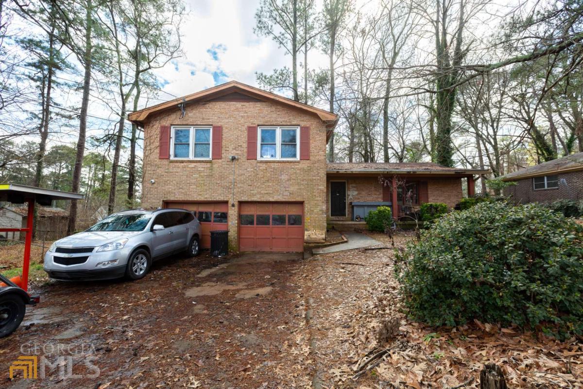 4915 Thompson Mill Road Lithonia, GA 30038 - Photo 1 of 1 a car parked in front of a house