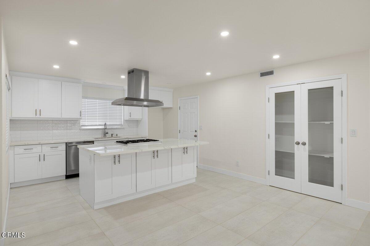 2075 Suner Circle Camarillo, CA 93010 - Photo 2 of 10 a kitchen with white cabinets and appliances