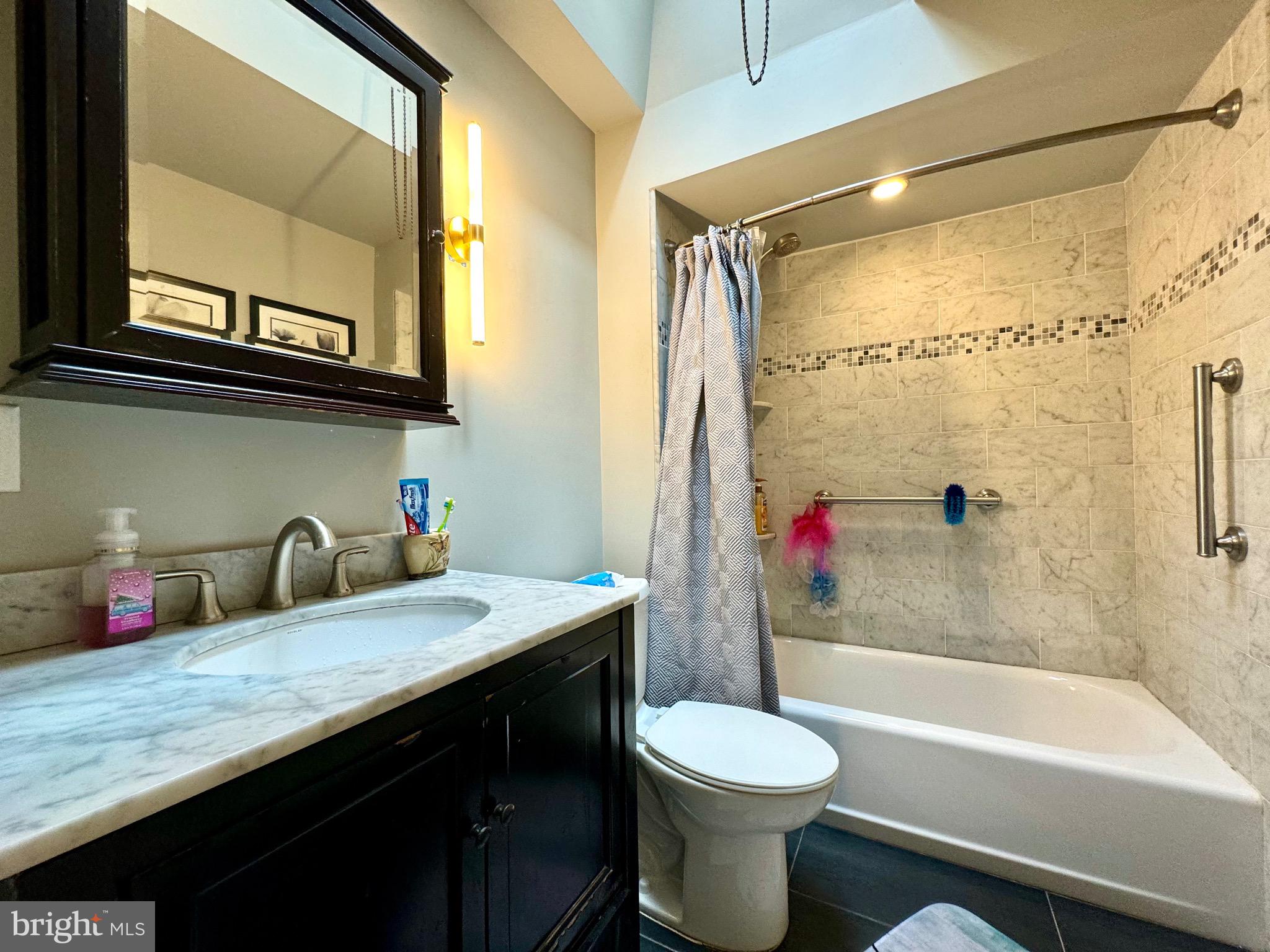 3335 Brighton Street Philadelphia, PA 19149 - Photo 15 of 24 a bathroom with a granite countertop sink toilet and shower