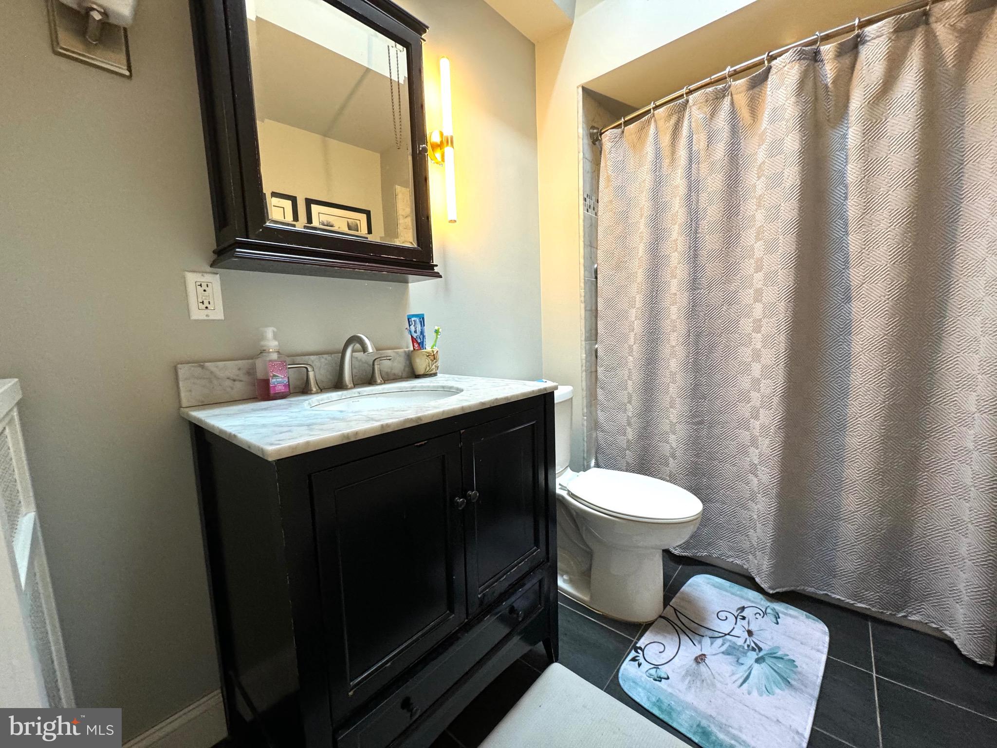 3335 Brighton Street Philadelphia, PA 19149 - Photo 16 of 24 a bathroom with a sink toilet and window