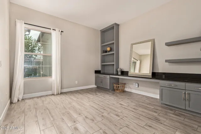 a view of a room with wooden floor and cabinet