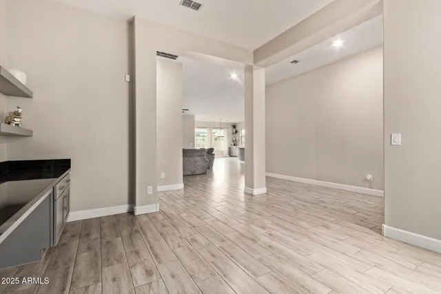 a view of empty room with wooden floor