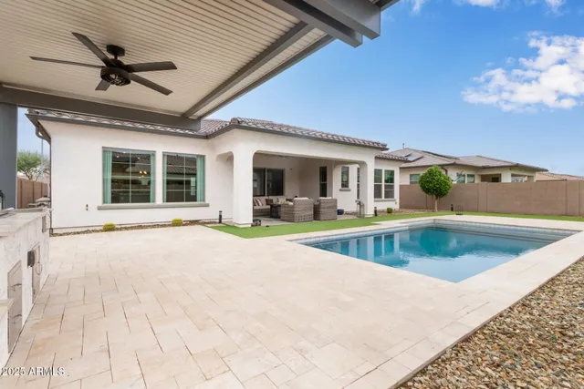 a view of swimming pool with seating space
