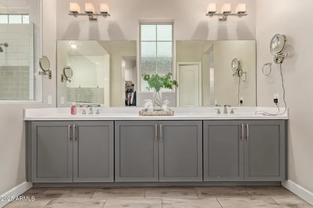 a bathroom with a double vanity sink and a mirror