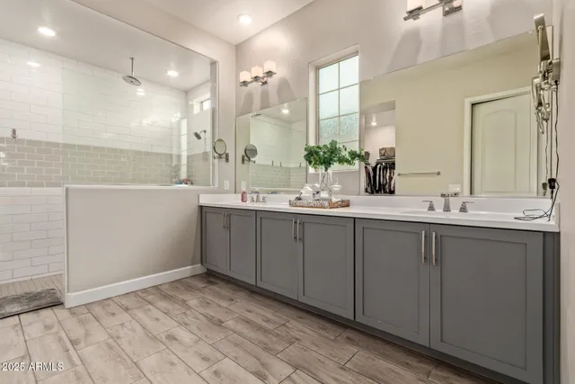 a bathroom with a double vanity sink and mirror