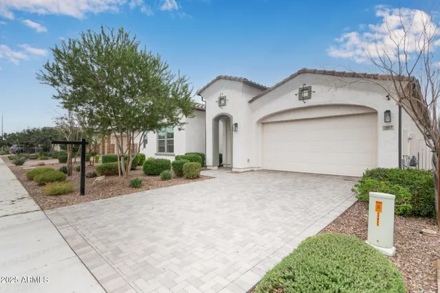 a front view of a house with a yard and garage