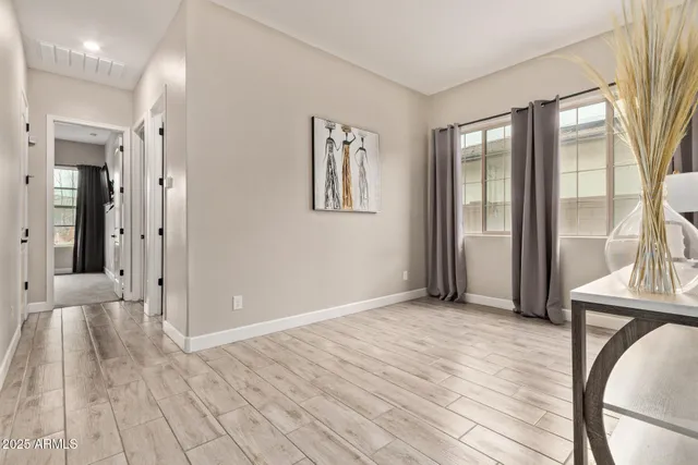 a view of a room with wooden floor and a balcony
