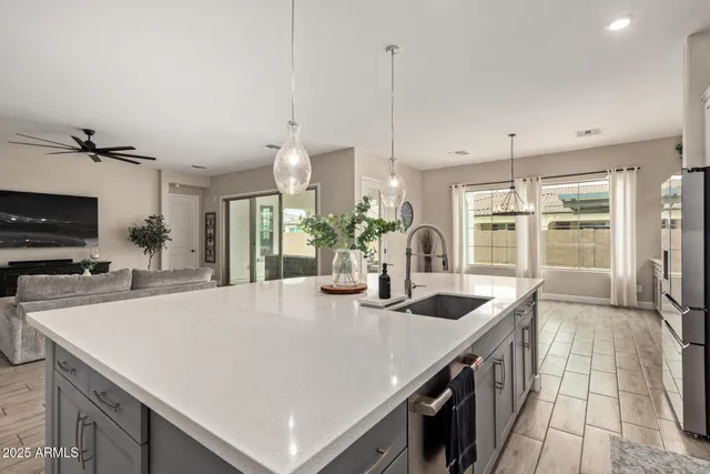 a kitchen with stainless steel appliances a sink a counter top space cabinets and furniture