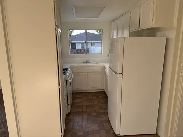 a utility room with cabinets washer and dryer