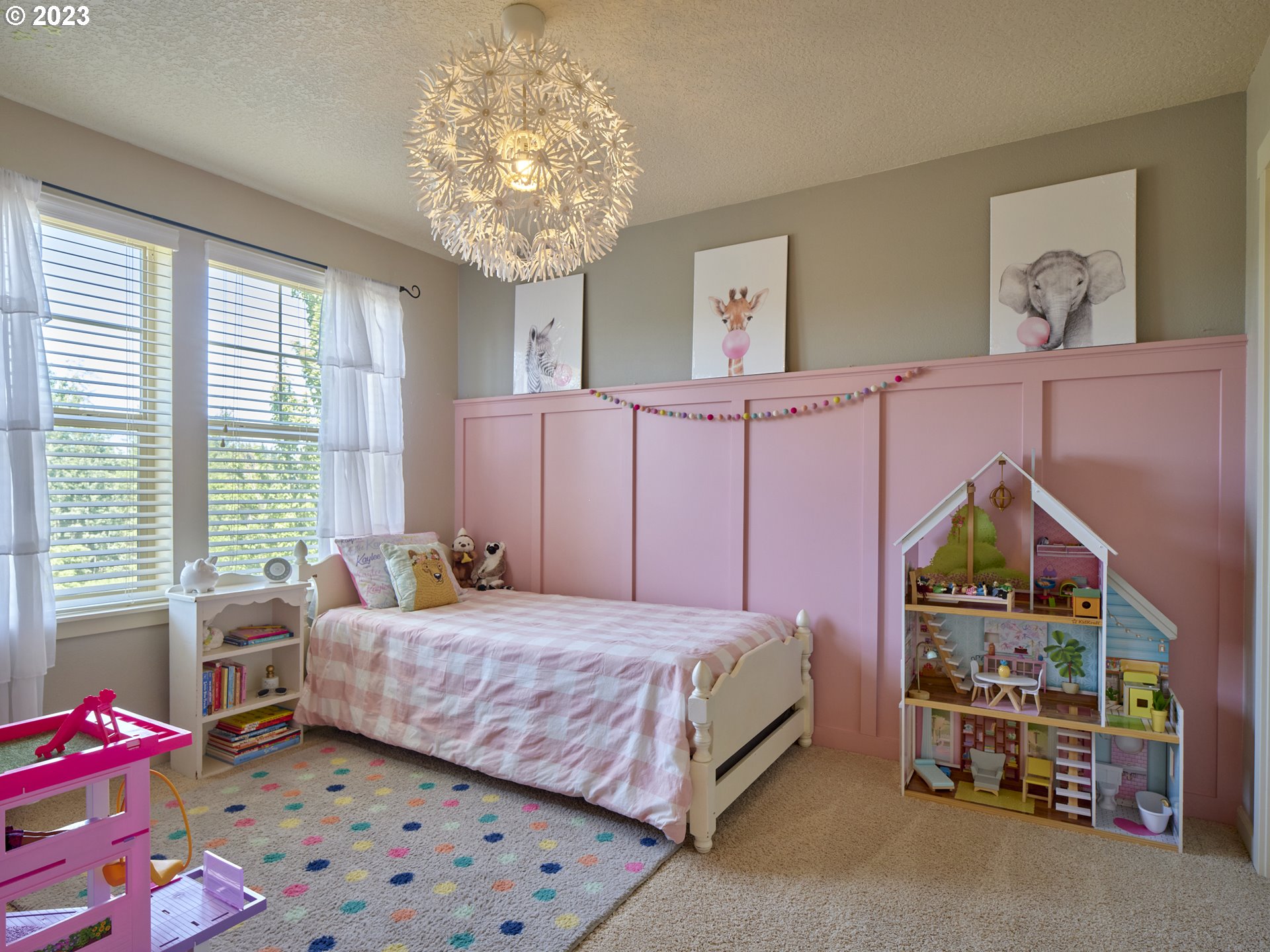 3551 North 1st Street Ridgefield, WA 98642 - Photo 16 of 38 a bedroom with a bed a chandelier and a window