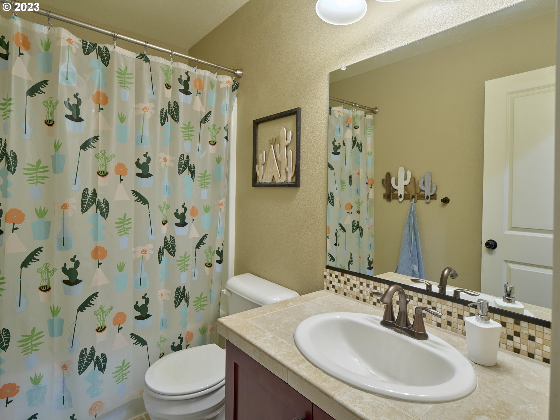 3551 North 1st Street Ridgefield, WA 98642 - Photo 17 of 38 a bathroom with a sink toilet a mirror and shower curtain
