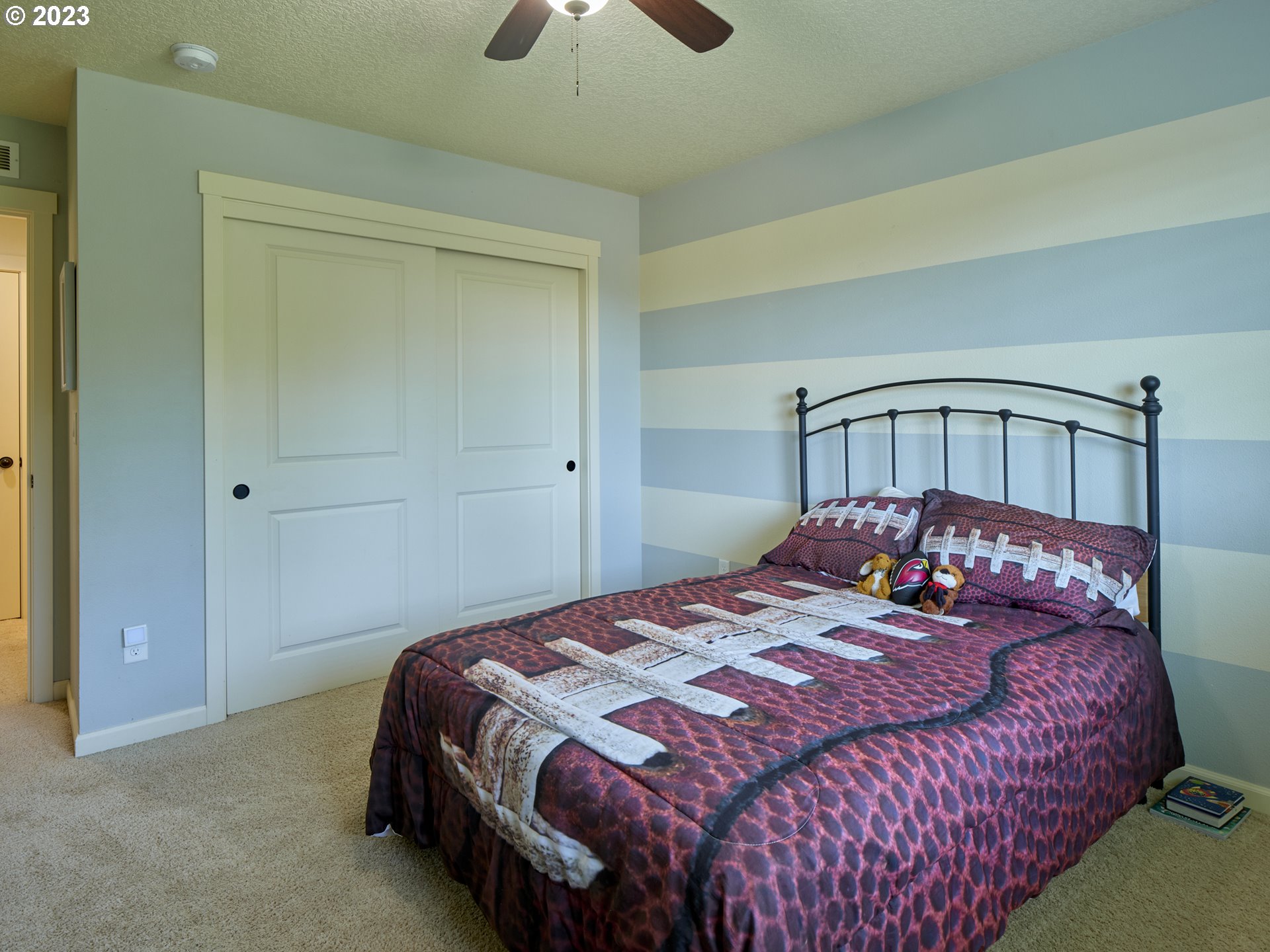 3551 North 1st Street Ridgefield, WA 98642 - Photo 19 of 38 a bedroom with a bed a chandelier and dresser
