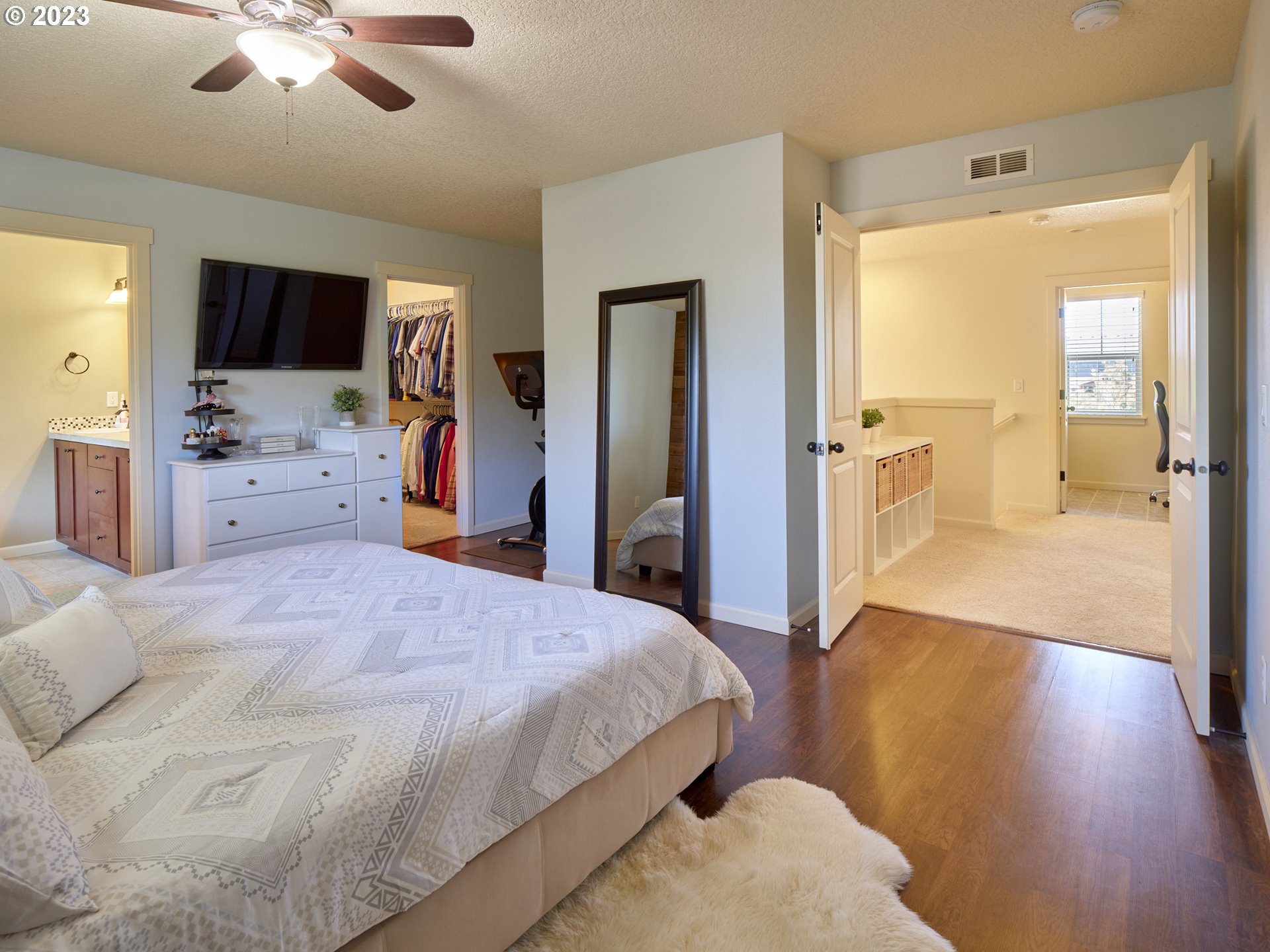 3551 North 1st Street Ridgefield, WA 98642 - Photo 21 of 38 a bedroom with a bed and a flat tv screen on dresser