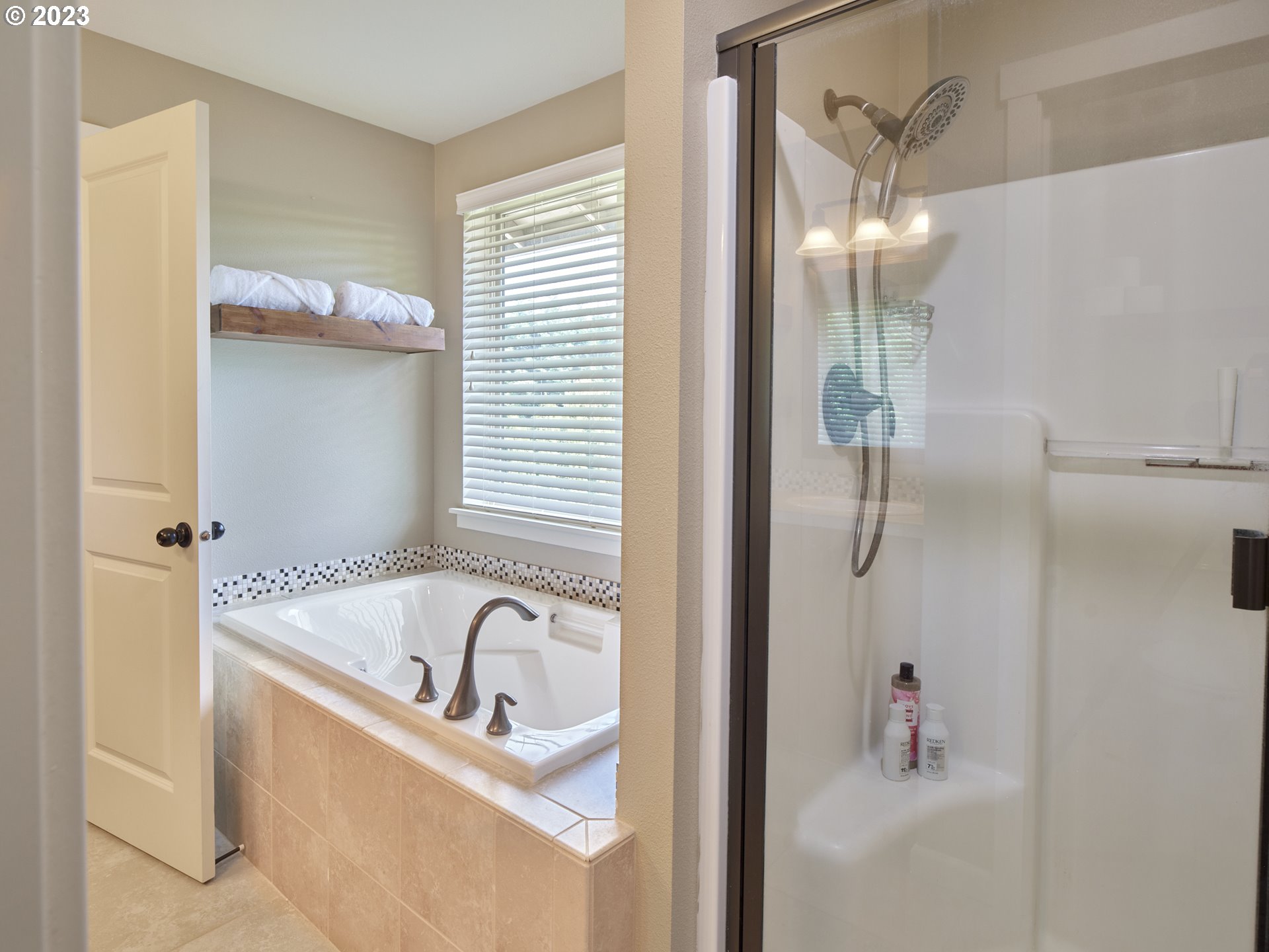 3551 North 1st Street Ridgefield, WA 98642 - Photo 23 of 38 a bathroom with a tub a mirror and a shower