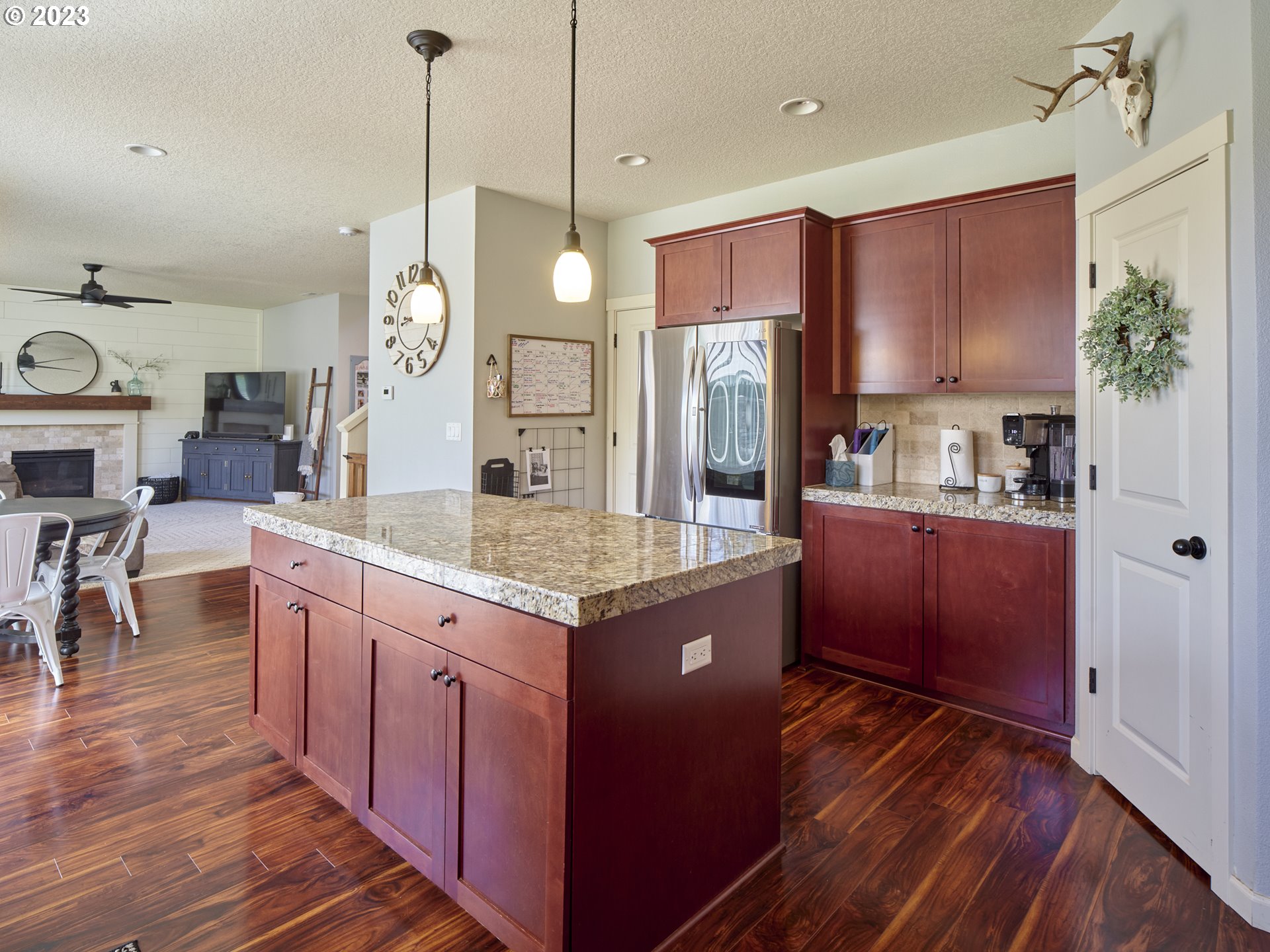 3551 North 1st Street Ridgefield, WA 98642 - Photo 10 of 38 a kitchen with stainless steel appliances granite countertop a stove a refrigerator a sink dishwasher and a dining table with wooden floor