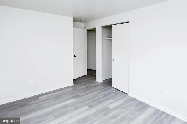 a view of a room with wooden floor and windows