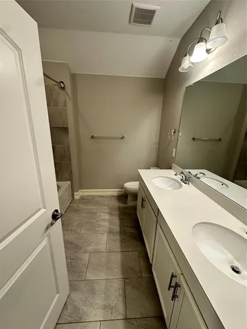 a bathroom with a tub sink and mirror
