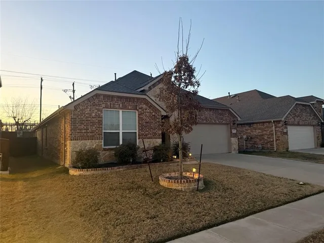 a view of a yard with wooden fence