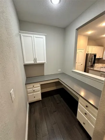 a kitchen with a stove and a wooden floor