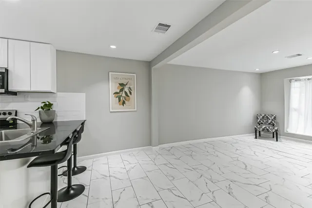 a bedroom with a bed a desk and chair