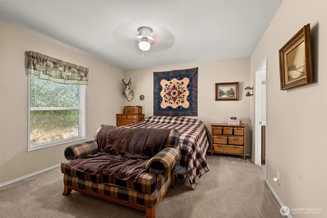 a bedroom with a bed and glass window