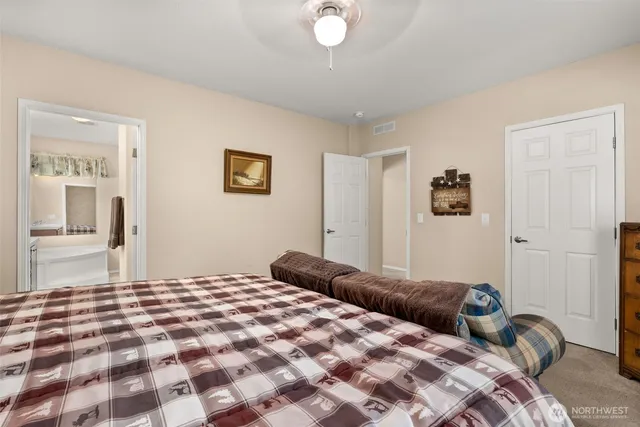 a bedroom with a large bed and a window