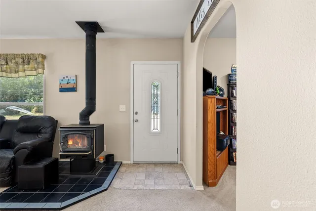 a view of a livingroom with wooden floor and furniture