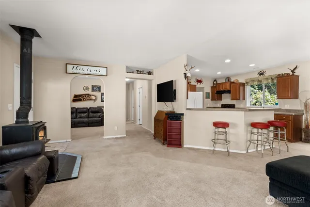 a living room with furniture and kitchen view
