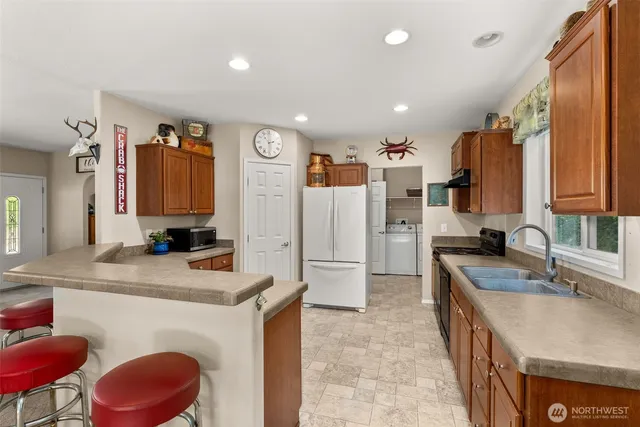 a kitchen with a sink stove and refrigerator
