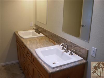 1111 East Ramon Road, Unit 52 Palm Springs, CA 92264 - Photo 8 of 11 a bathroom with a sink and a mirror