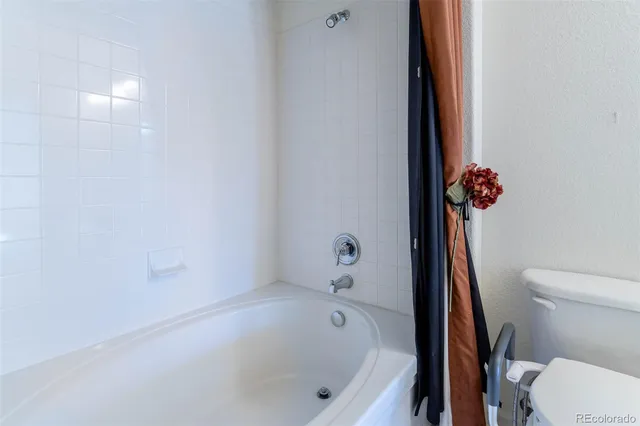 a bathroom with a bathtub and a toilet