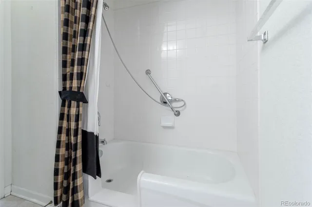 a bathroom with a bathtub and shower