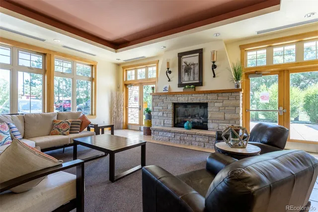 a living room with furniture fireplace and a large window