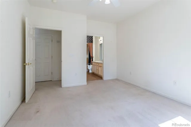 an empty room with closet and mirror