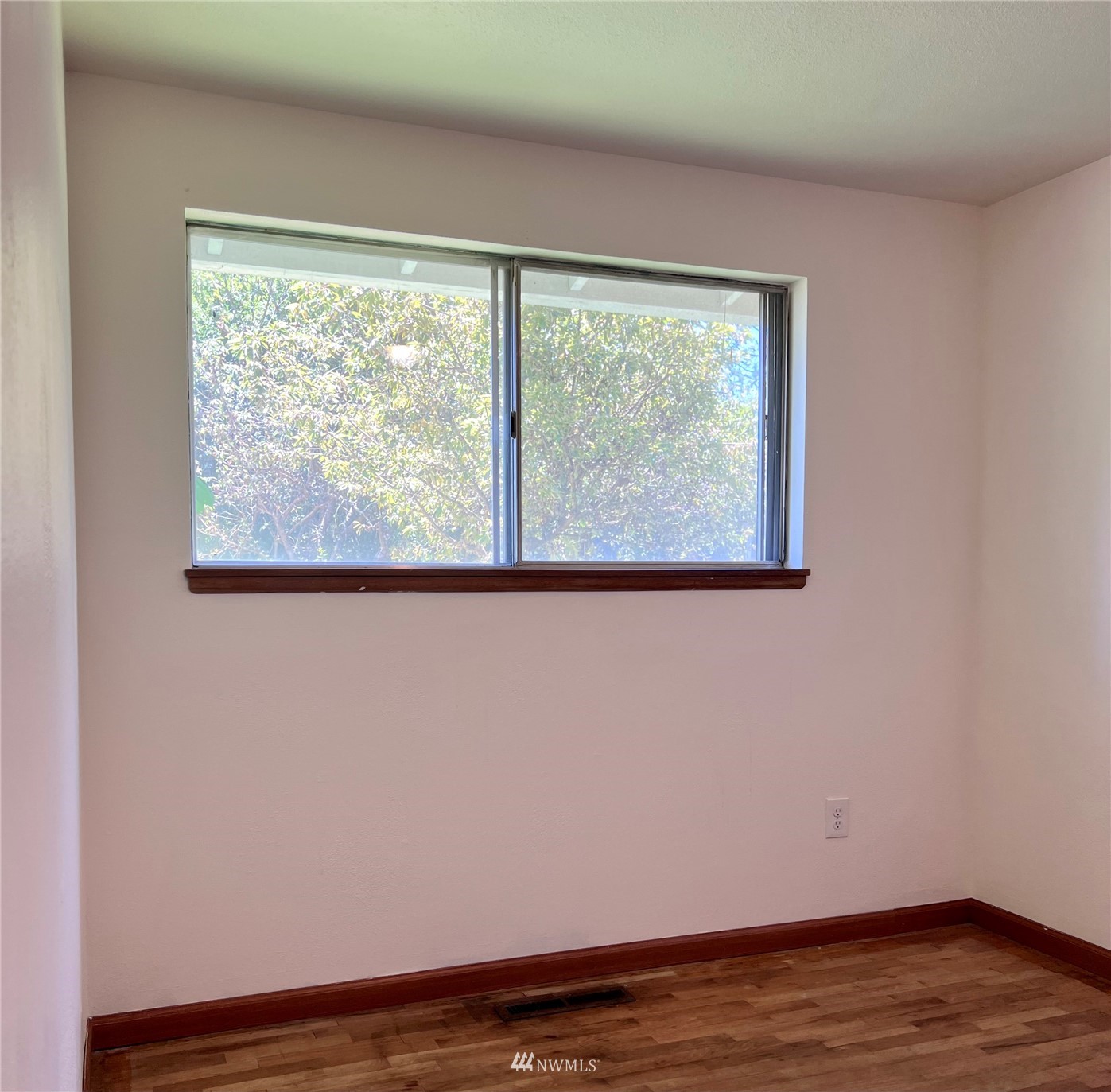 1166 Brookdale Road East Tacoma, WA 98445 - Photo 12 of 20 a view of a room with wooden floor and a window