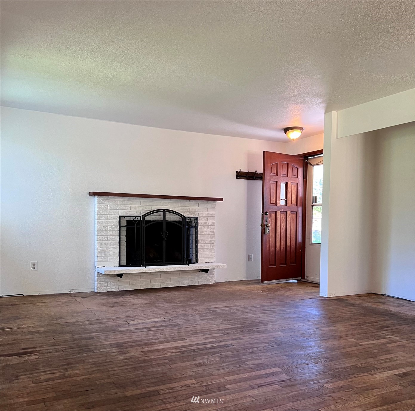 1166 Brookdale Road East Tacoma, WA 98445 - Photo 3 of 20 a view of an empty room with wooden floor and a window