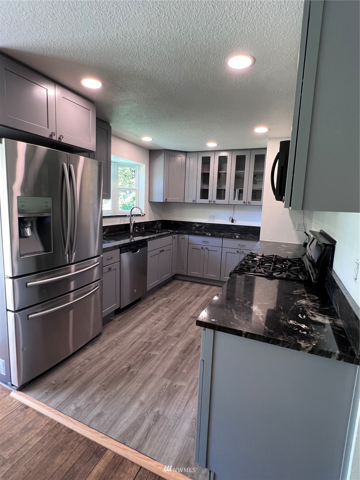 1166 Brookdale Road East Tacoma, WA 98445 - Photo 5 of 20 a kitchen with granite countertop a refrigerator and a stove