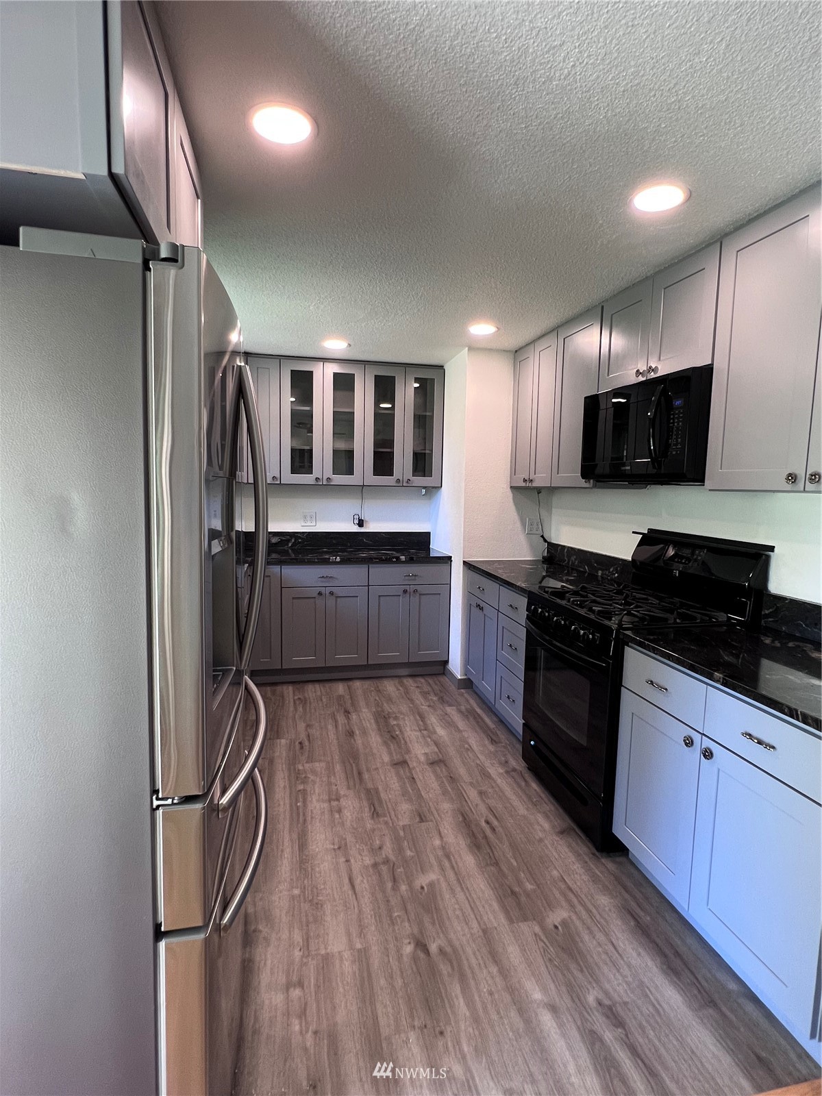 1166 Brookdale Road East Tacoma, WA 98445 - Photo 6 of 20 a kitchen with stainless steel appliances granite countertop a refrigerator and a stove top oven