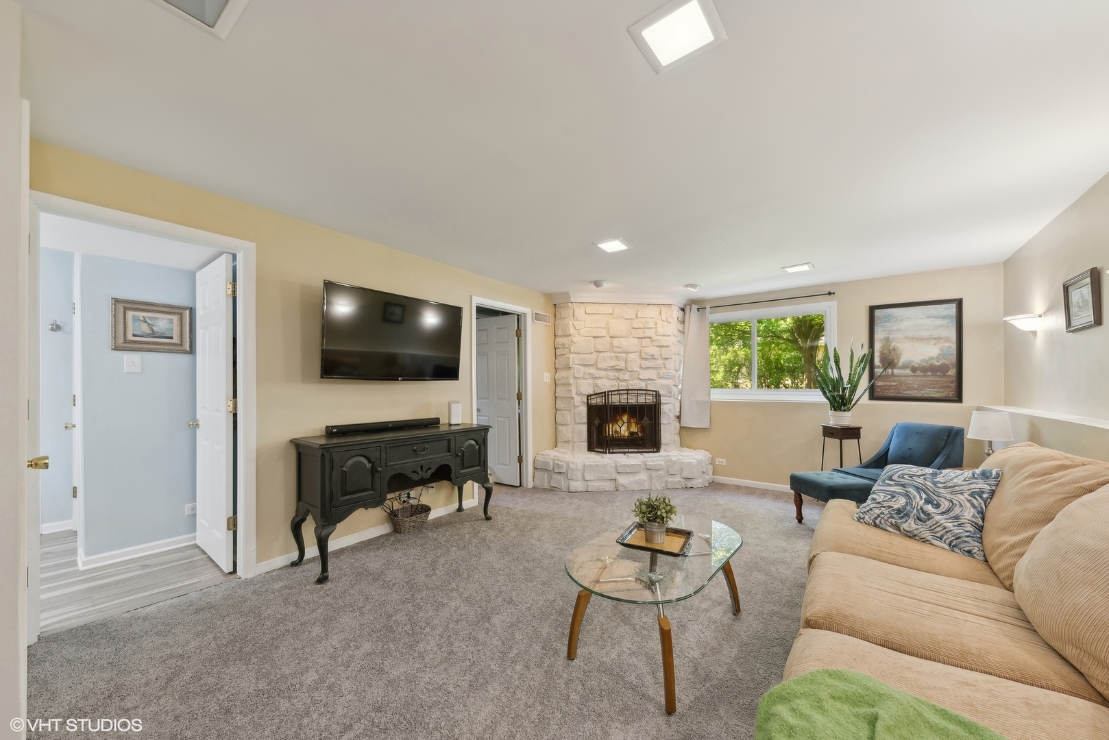 750 Leaf Court Bartlett, IL 60103 - Photo 11 of 17 a living room with furniture flat screen tv and a fireplace