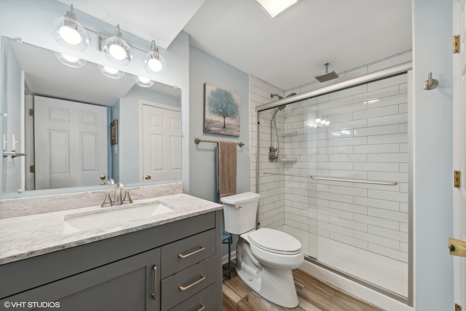 750 Leaf Court Bartlett, IL 60103 - Photo 12 of 17 a bathroom with a granite countertop sink toilet a mirror a vanity and shower