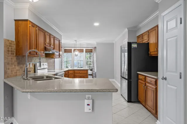 a living room with furniture fireplace and a large window