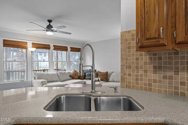 a kitchen with stainless steel appliances granite countertop a sink a refrigerator and a granite counter tops