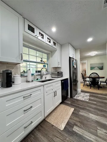 a kitchen with stainless steel appliances a refrigerator sink and stove