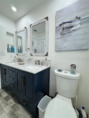 a bedroom with two beds and a chandelier