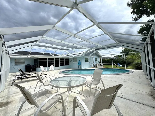 a view of a swimming pool with a patio