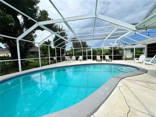 a view of a house with a backyard