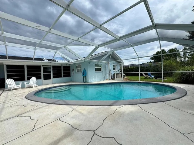 a view of a house with a backyard and a garden
