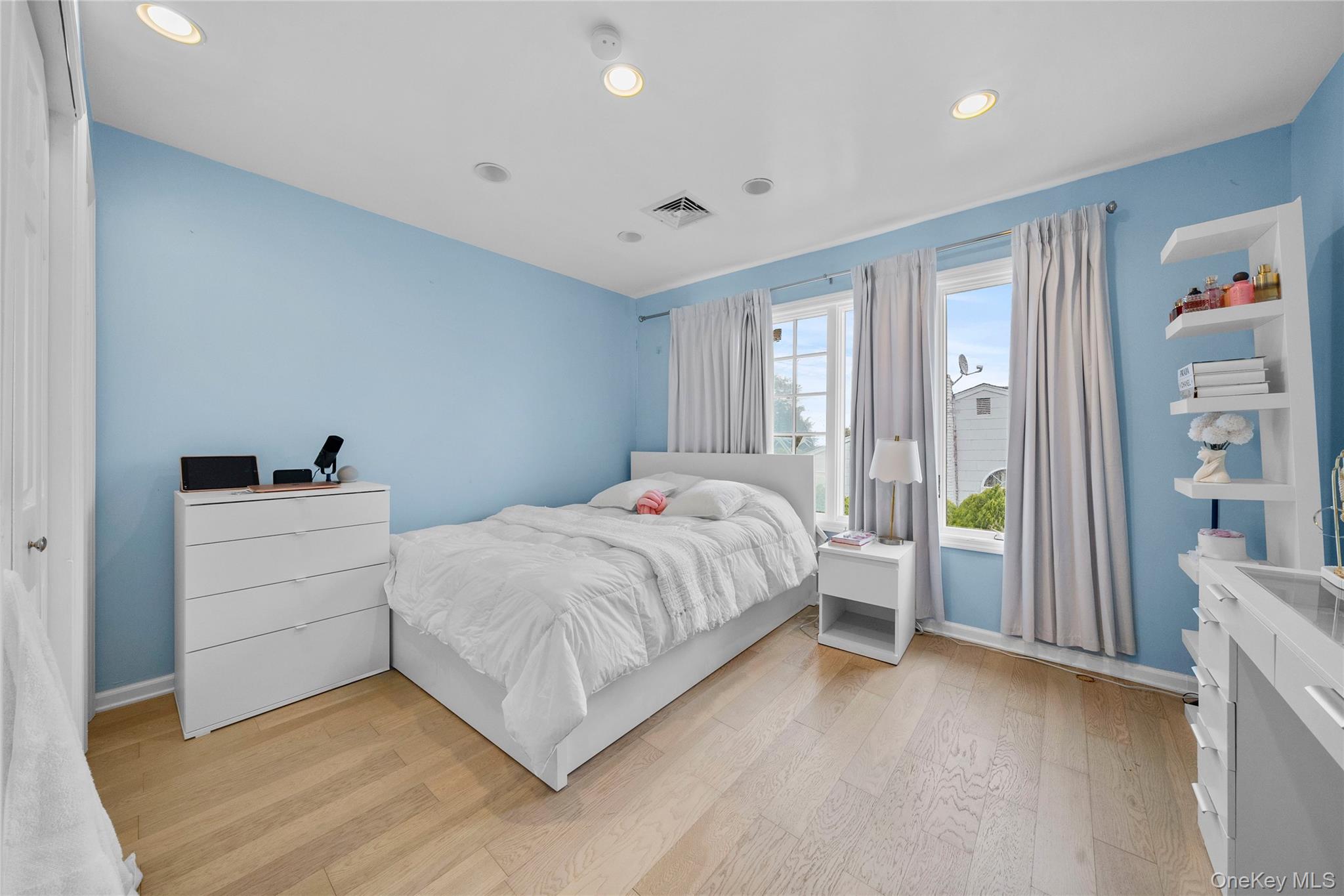 Undisclosed Address Freeport, NY 11520 - Photo 15 of 22 a room with a bed and a window