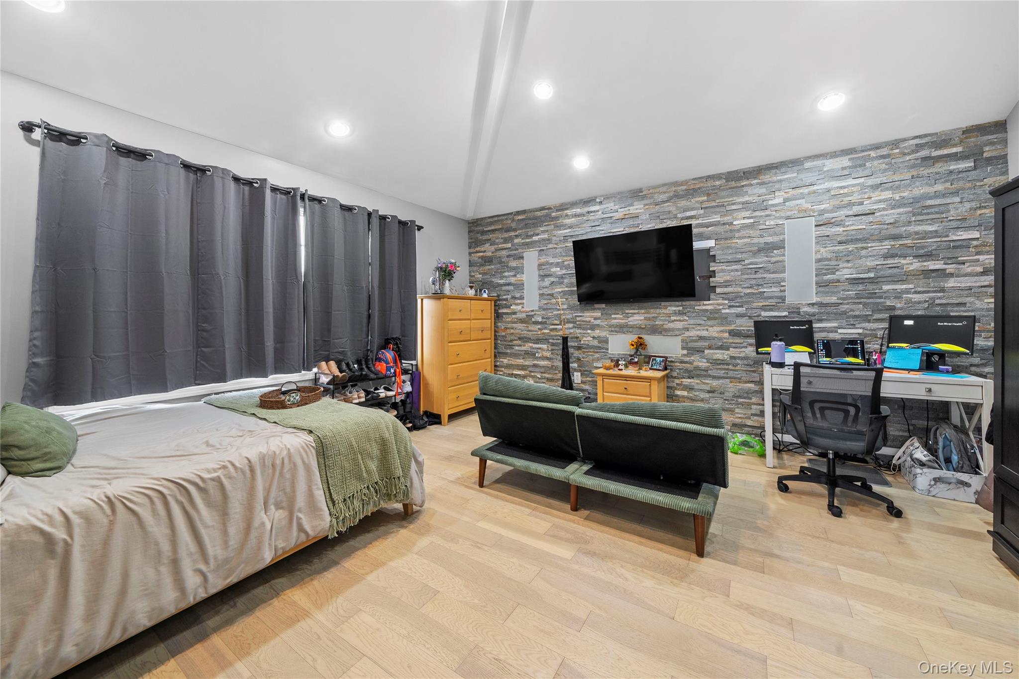 Undisclosed Address Freeport, NY 11520 - Photo 16 of 22 a bedroom with a bed and a flat screen tv